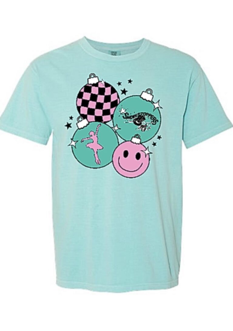 A light blue t-shirt featuring four colorful ornaments: one with a pink and black checkerboard pattern, one with “Showstoppers” text, one with a dancer silhouette, and one with a pink smiley face—perfect for kids dance classes or any dance studio. -Showstoppers Dance Studio