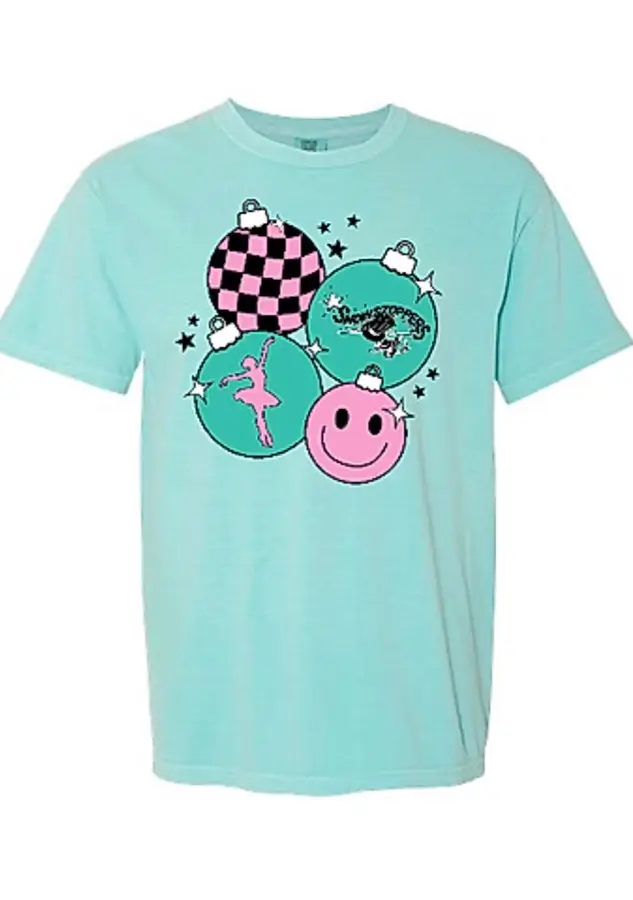 Light blue T-shirt featuring four pastel ornaments with different designs: a pink smiley face, a dancer, a black-checked pattern, and black text, surrounded by small stars. -Showstoppers Dance Studio